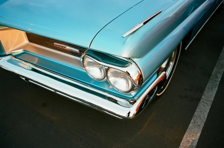 an old car has a blue top with a brown stripe