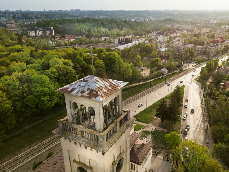 an old building sits atop a hill near a city