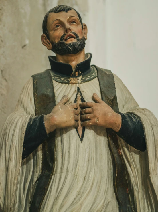 statue of saint john with cloth and cross