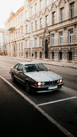 an older bmw sitting alone in the street