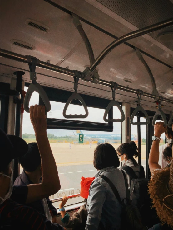 people riding on an inner city bus with large windows