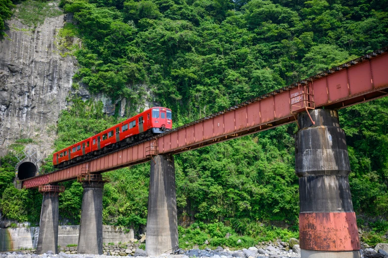 a train traveling over a bridge above a body of water
