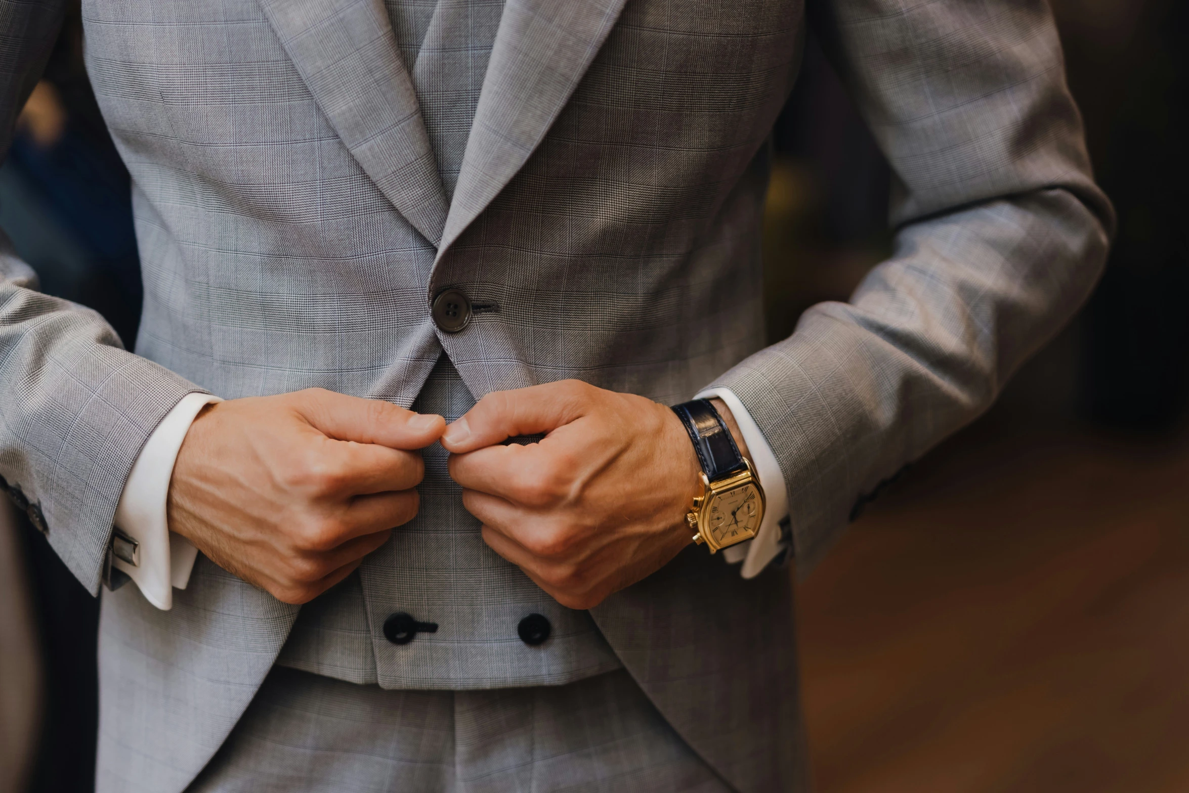 a man is shown adjusting his suit