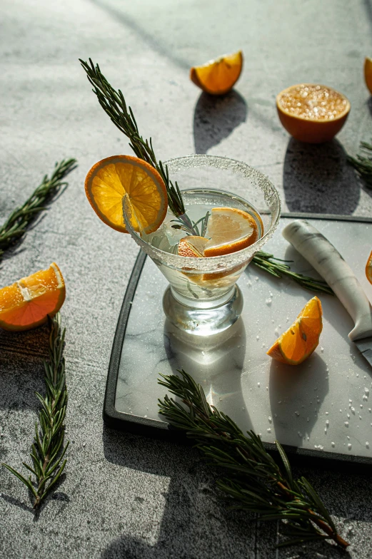 a cut orange sitting on top of a glass on a counter