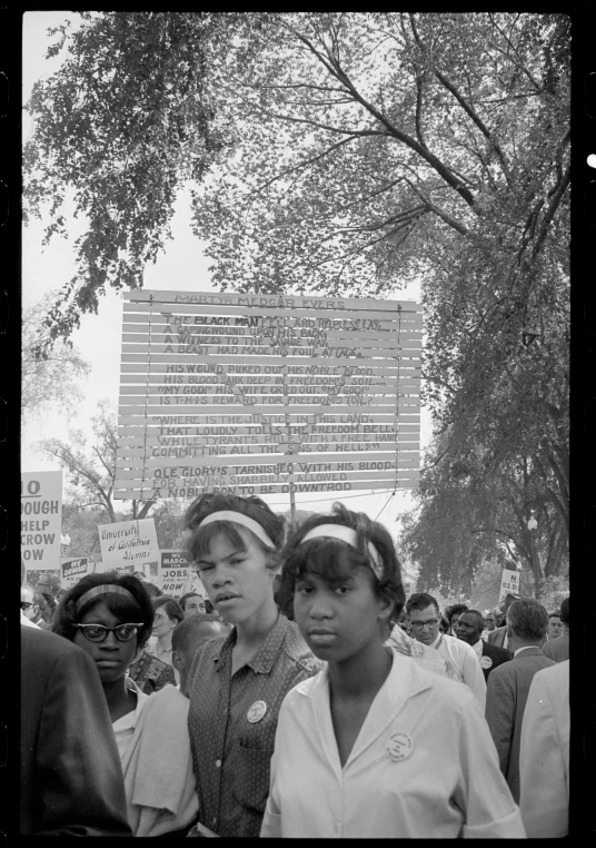 there are several people in the picture with a sign above them