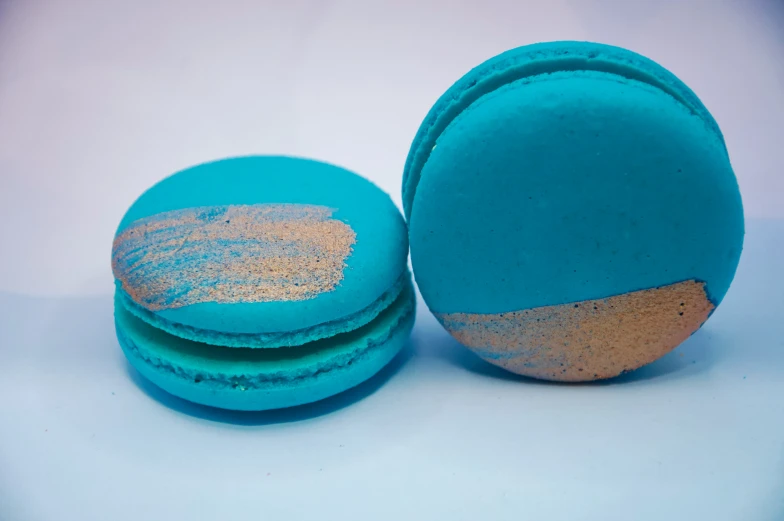 some blue macaroons have gold colored confetti