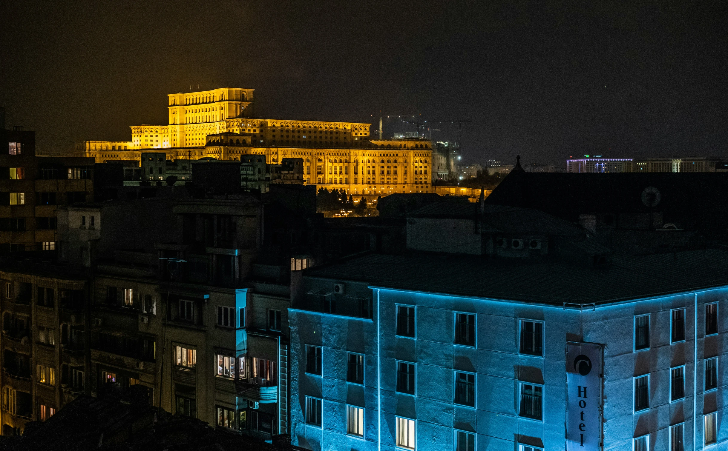 a night time view of some buildings and lights