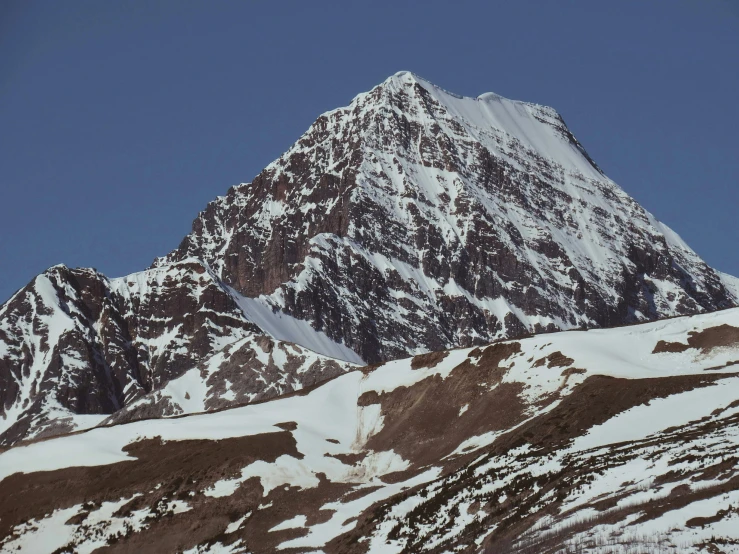 there is snow on the mountain as it sits