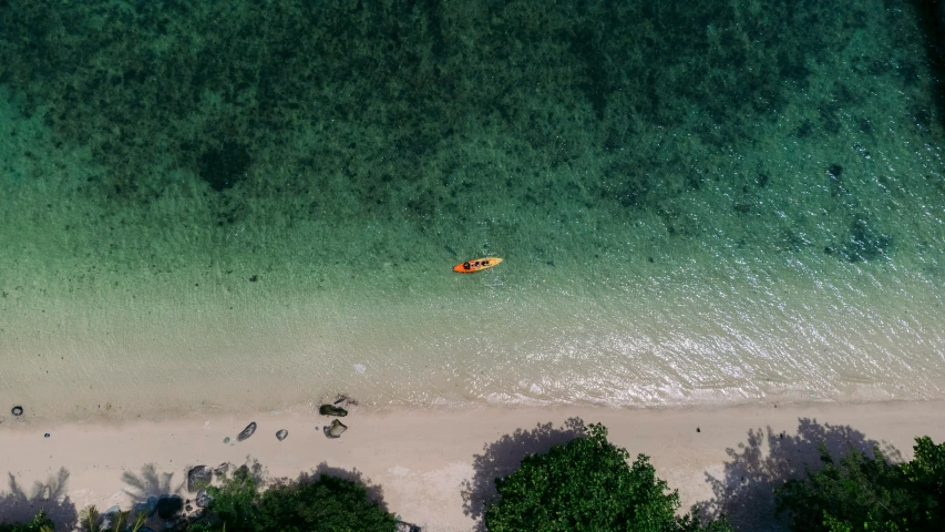 an aerial view of a small boat on the water