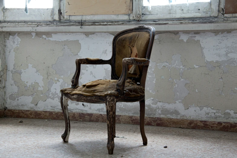 the side view of an old chair in an abandoned room