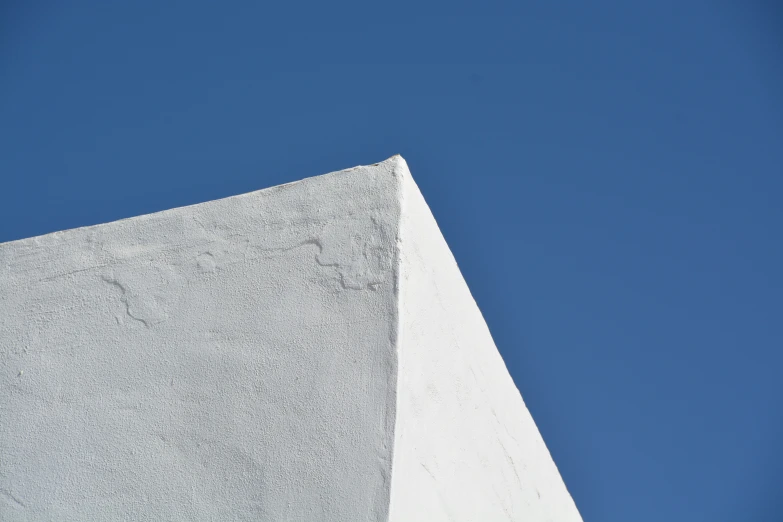 the top of a white building with a clock