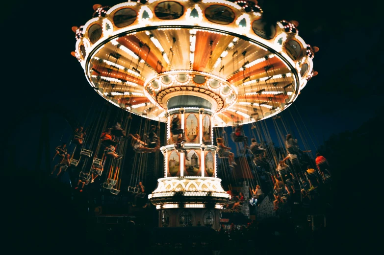 a large merry go round rides in the dark