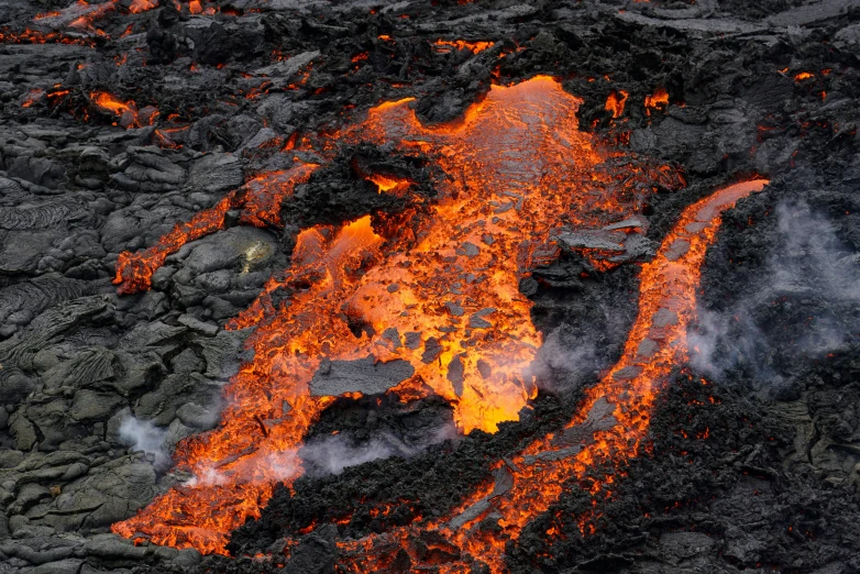 a lava flow and a plume of steam in the center