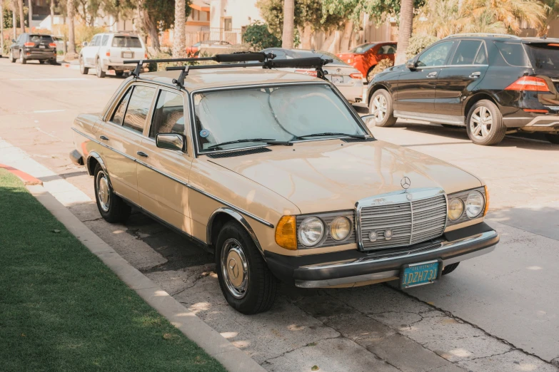 an old car parked on the side of a road