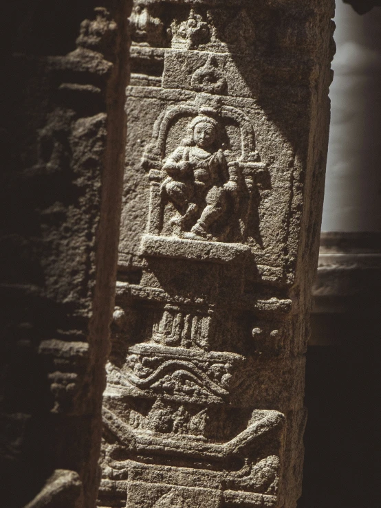 a large carved statue sitting under a window