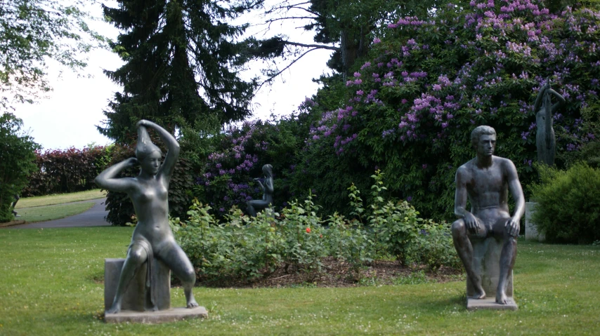 the sculptures are in the middle of a lush green field