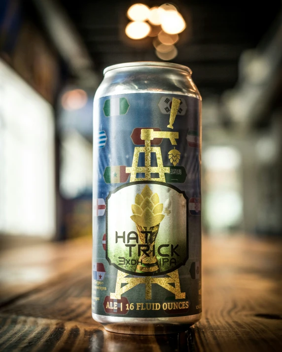 a can of beer with a crown emblem sits on a table