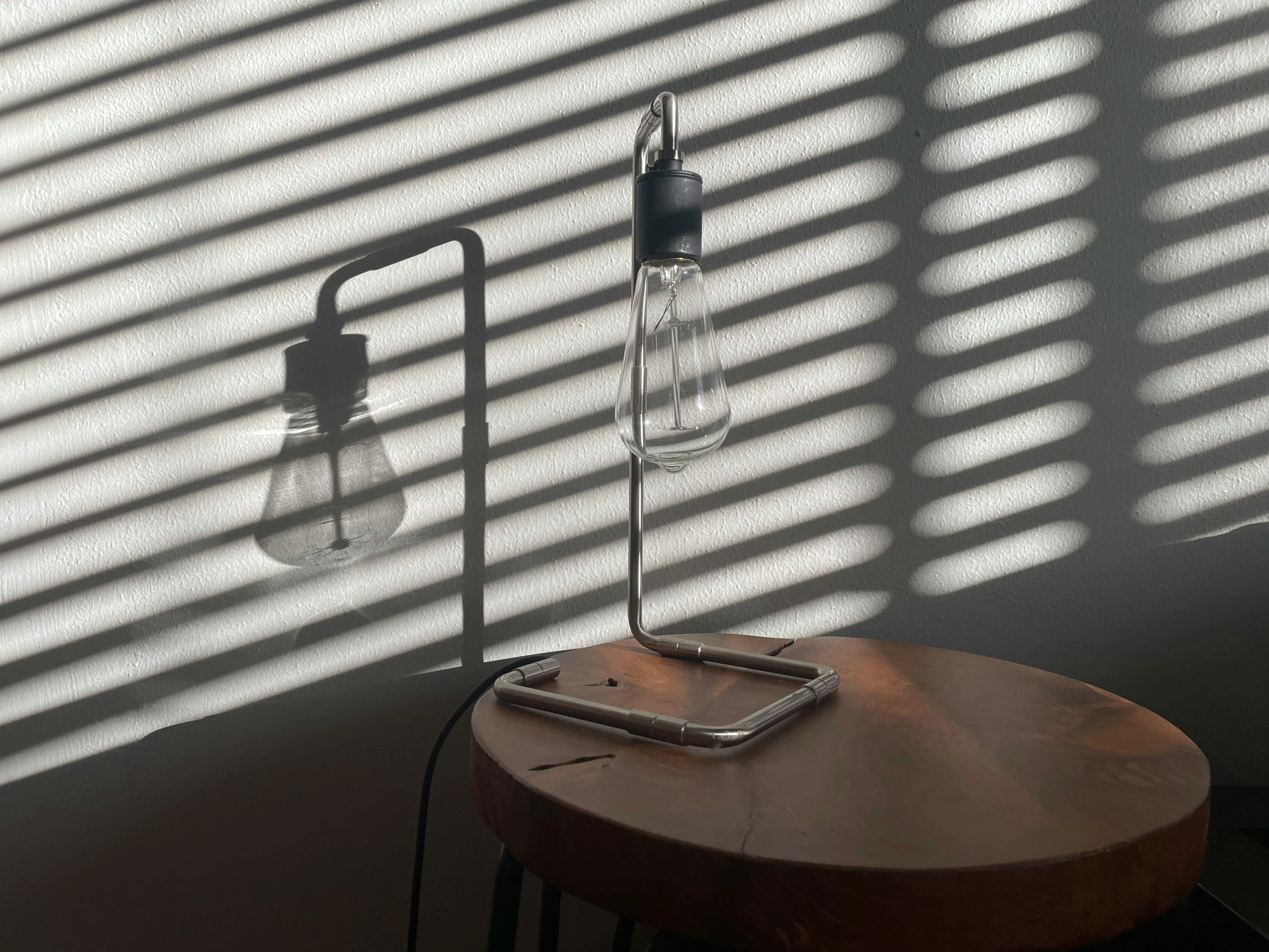 a wooden table with a lamp on top of it