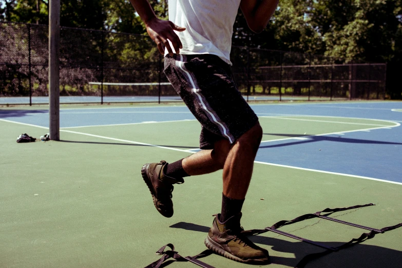 a man is playing tennis on a green court