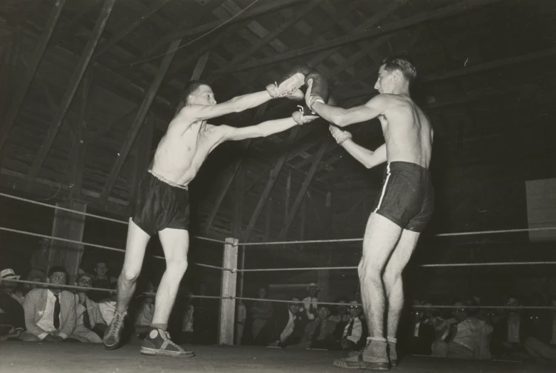 two men are fighting in a wrestling ring