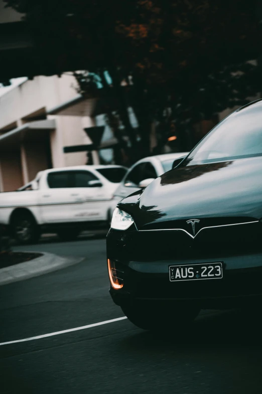 the back of a car is seen driving down a busy street