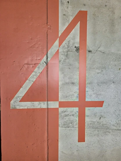 a red sign with numbers in it on a wall