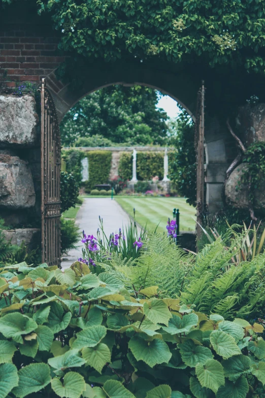 an archway leading to a beautiful garden