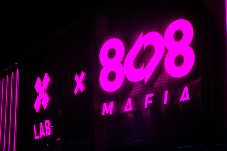 pink neon lights and black shipping containers on a dark background