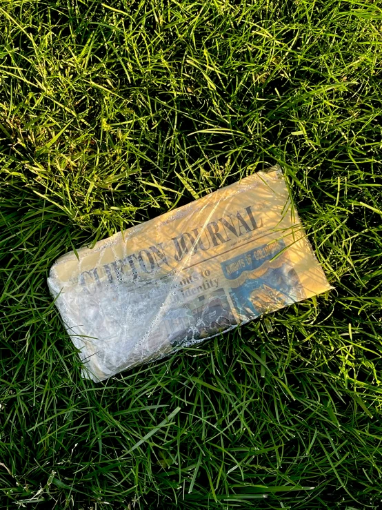 a piece of plastic wrapped in foil laying on the ground