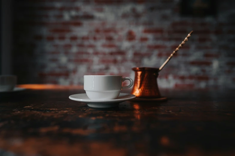 a coffee mug and a teaspow sitting on a table