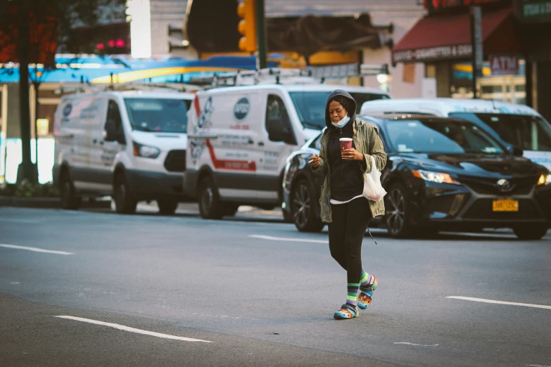 a girl skateboarding down a busy street in the city
