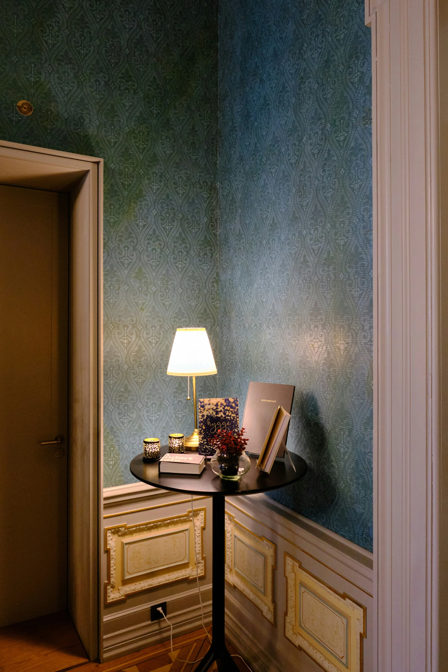 a lamp is placed on the table next to the desk