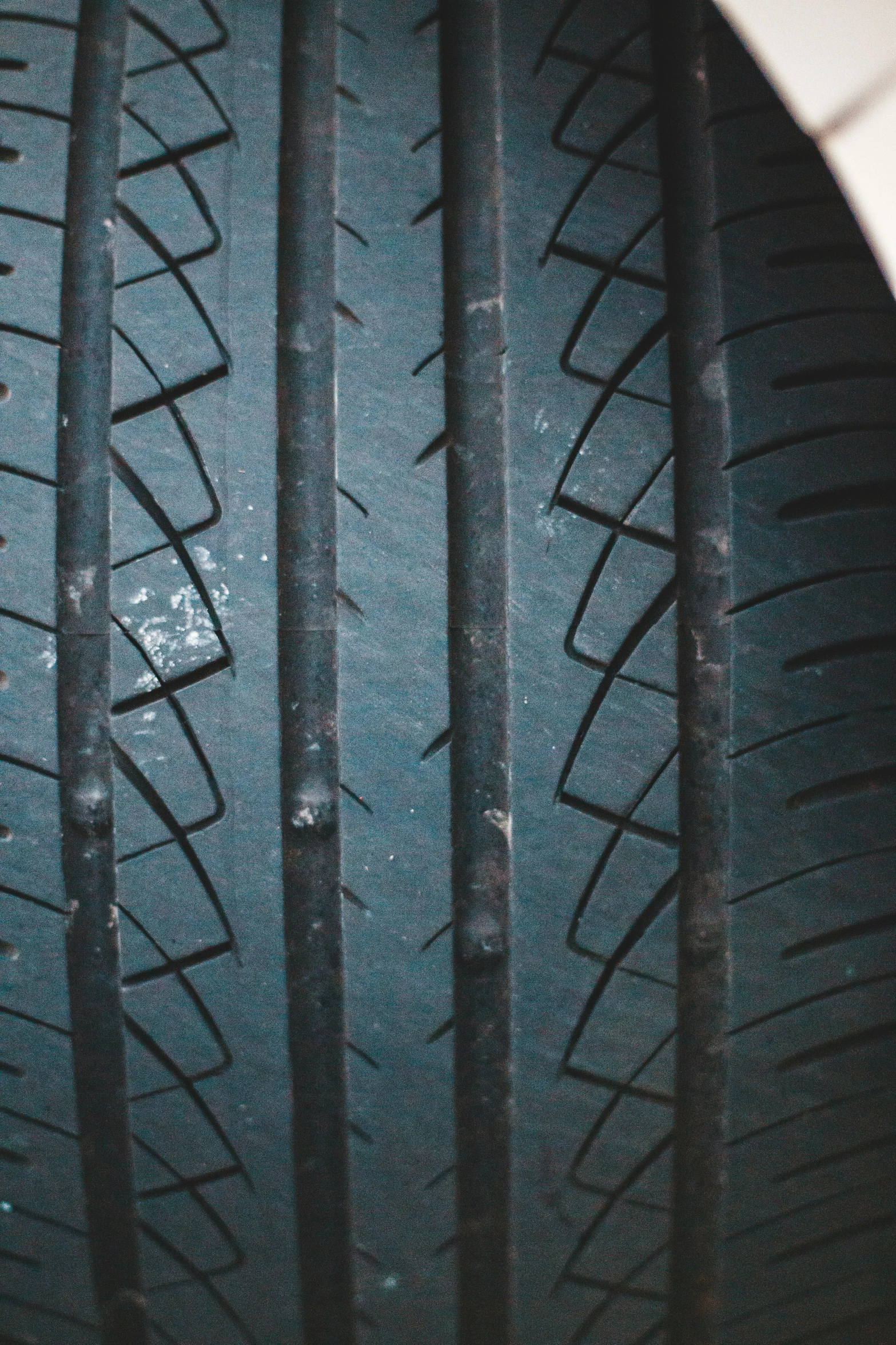 close up of a tire tread on a white car