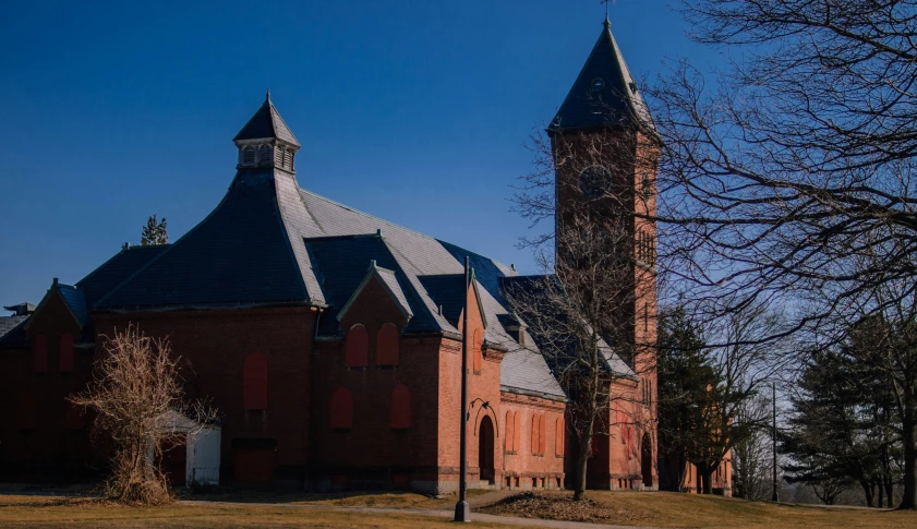 there is an old building and an older clock tower