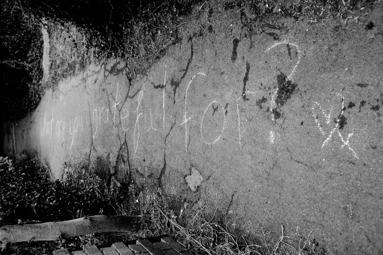 a wall covered in graffiti with writing written on it