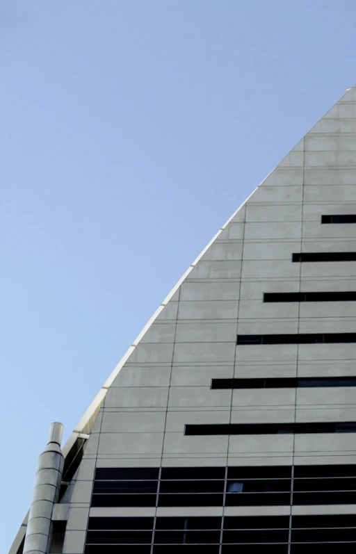 an airplane is flying by a tall building