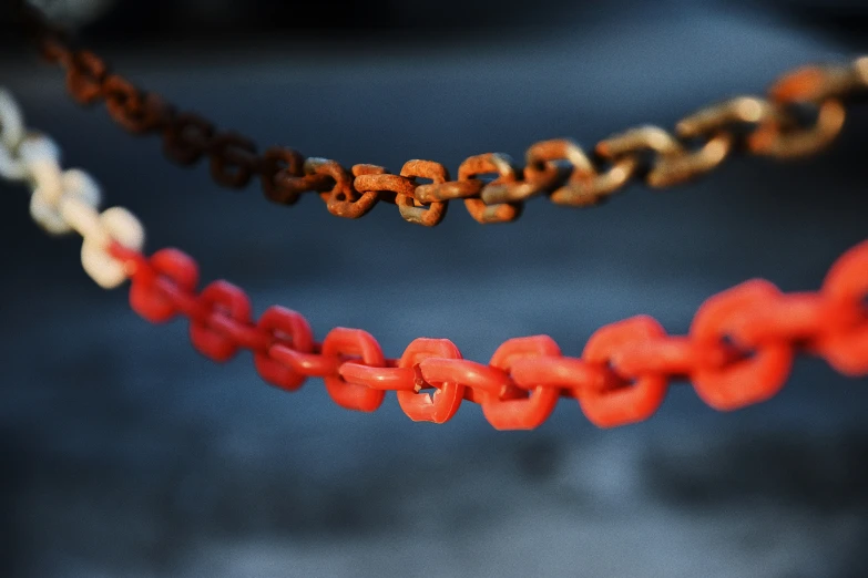 an orange and red piece of jewelry hanging from the ceiling