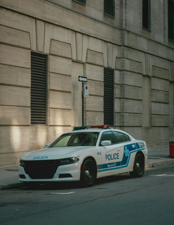 a police car parked along the curb of a street