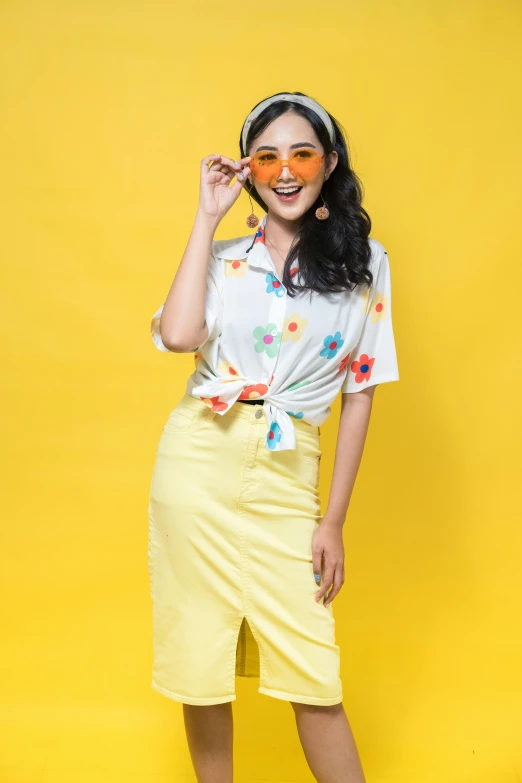 a young woman posing for a po with bright yellow paint