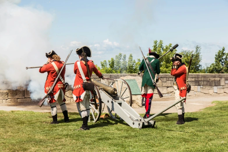 an american civil war reenactment with firing and cannon in the foreground