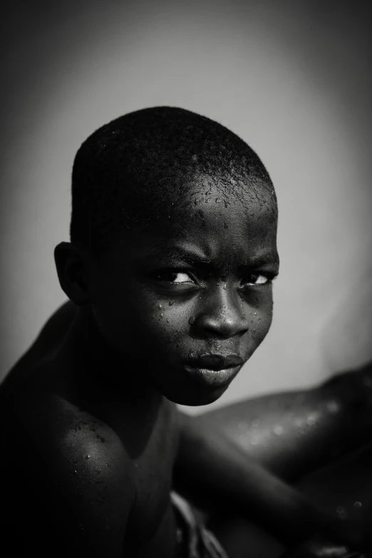 a boy poses for a black and white po