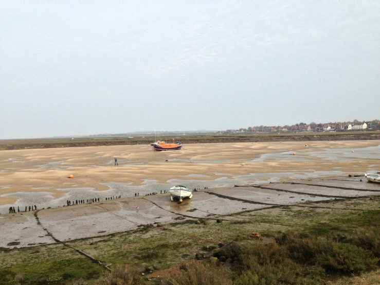 boats in the shallow water near the beach