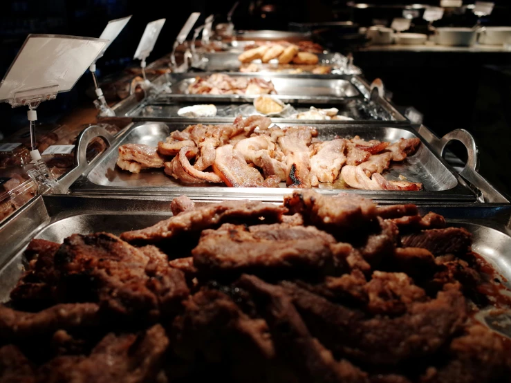 various foods are being prepared on a buffet