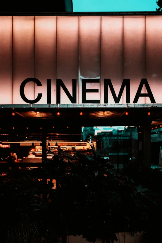 an old movie building is lit up at night