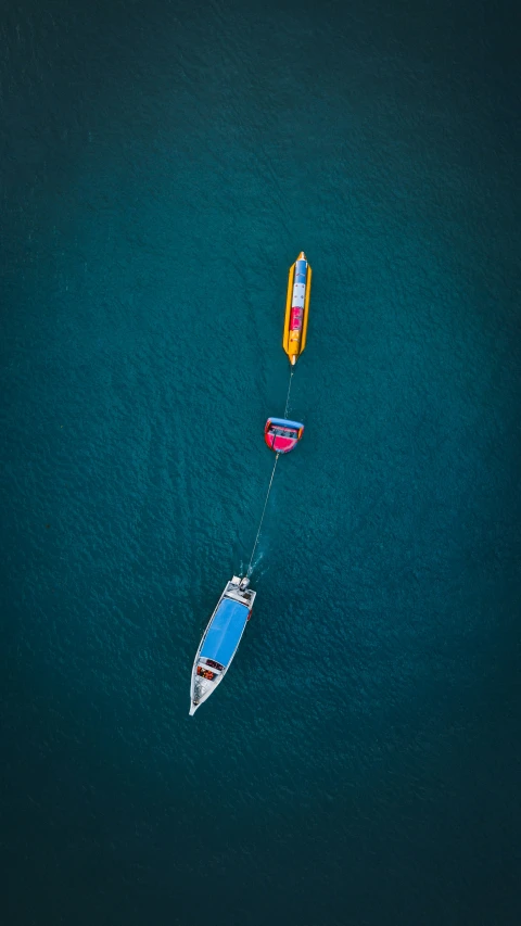 a boat in the water with a wake board being pulled