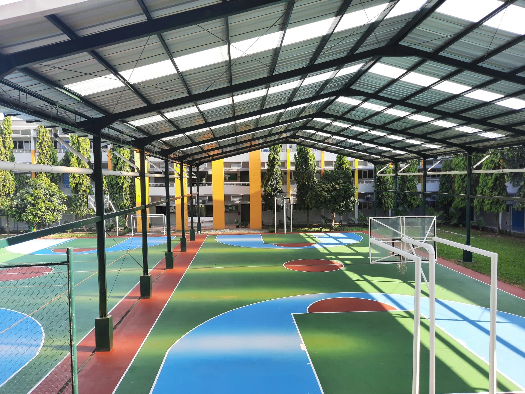 a group of outdoor basketball courts with nets