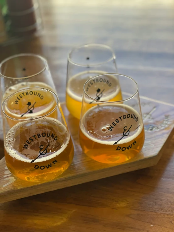 four beers sitting on top of a tray