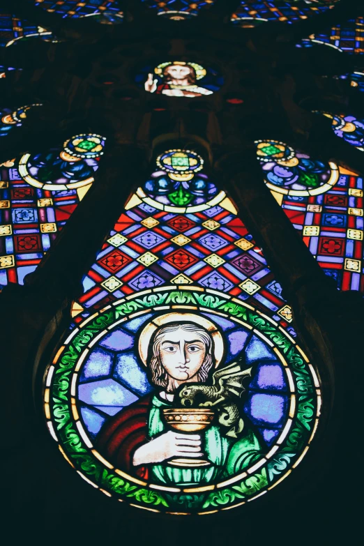 a stained glass window depicting jesus in the center