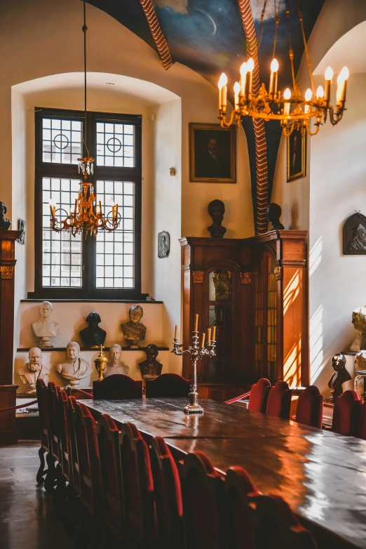 a dining room with red chairs around the table