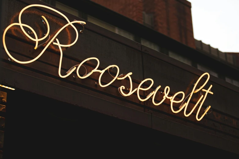 a neon sign is lit up above the entrance to a store